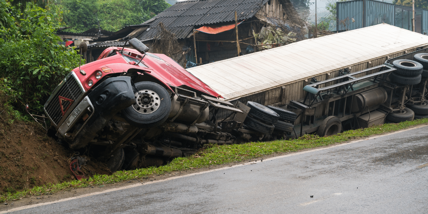 A truck lying by the side of the highway after an accident