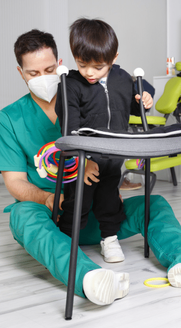 physician helping child with cerebral palsy