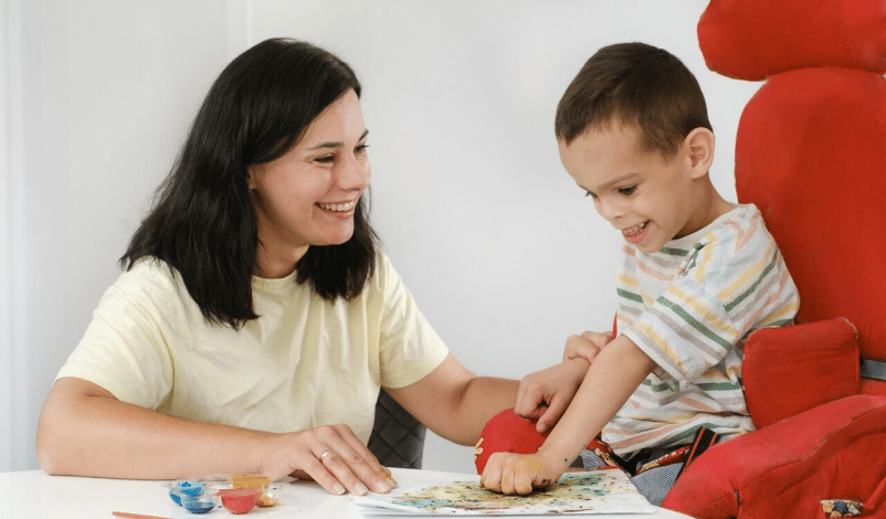 woman and child with cerebral palsy sitting at table - cerebral palsy facts and statistics